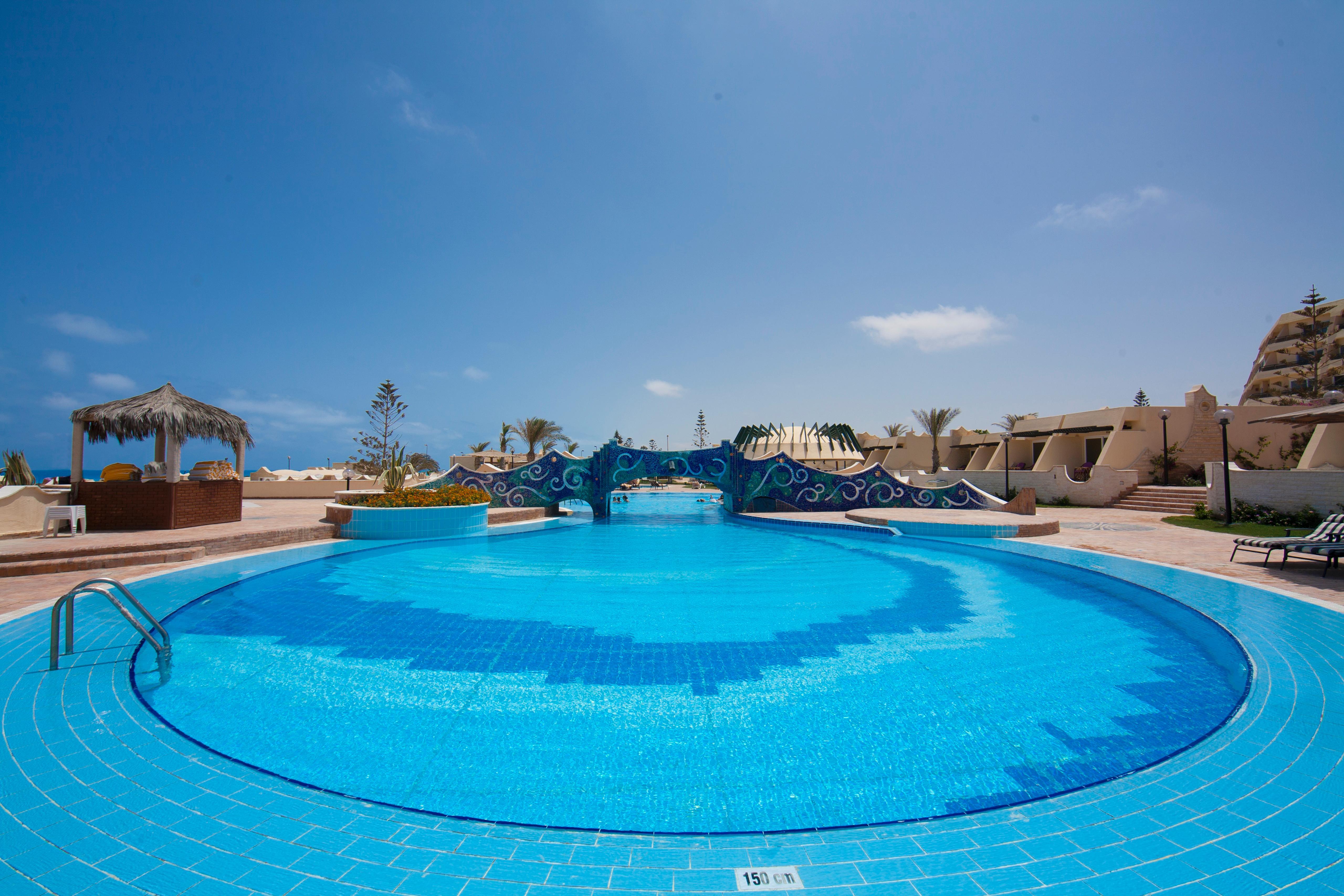 Borg El Arab Beach Resort Esterno foto A swimming pool at a resort in Egypt