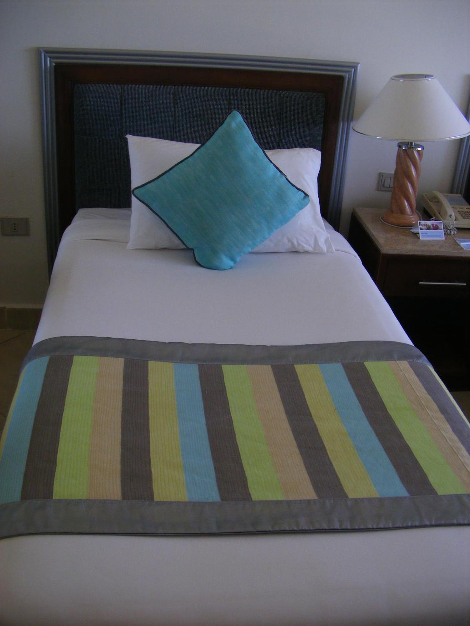 Borg El Arab Beach Resort Esterno foto A bed with a bed runner